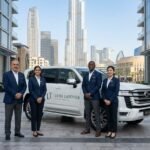 Team posing with land cruiser