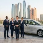 Team standing by Toyota Previa