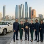 Tour guides posing by vehicles