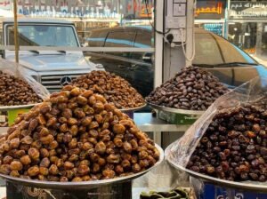 A market stall piled with dates and dried fruit for sale