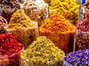 Colourful piles of dried flowers and spices displayed at a souk stall