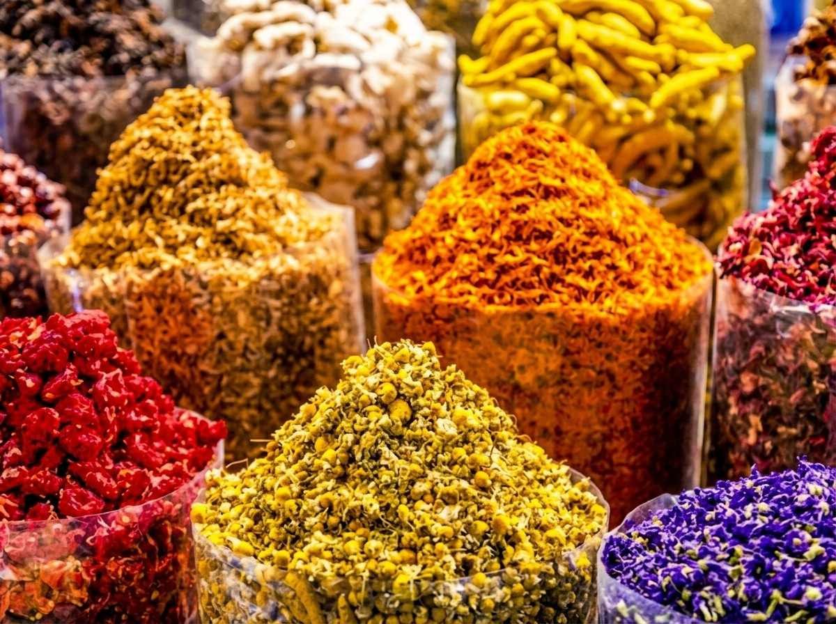 Colourful dried flowers and spices displayed at an Old Dubai souk stall